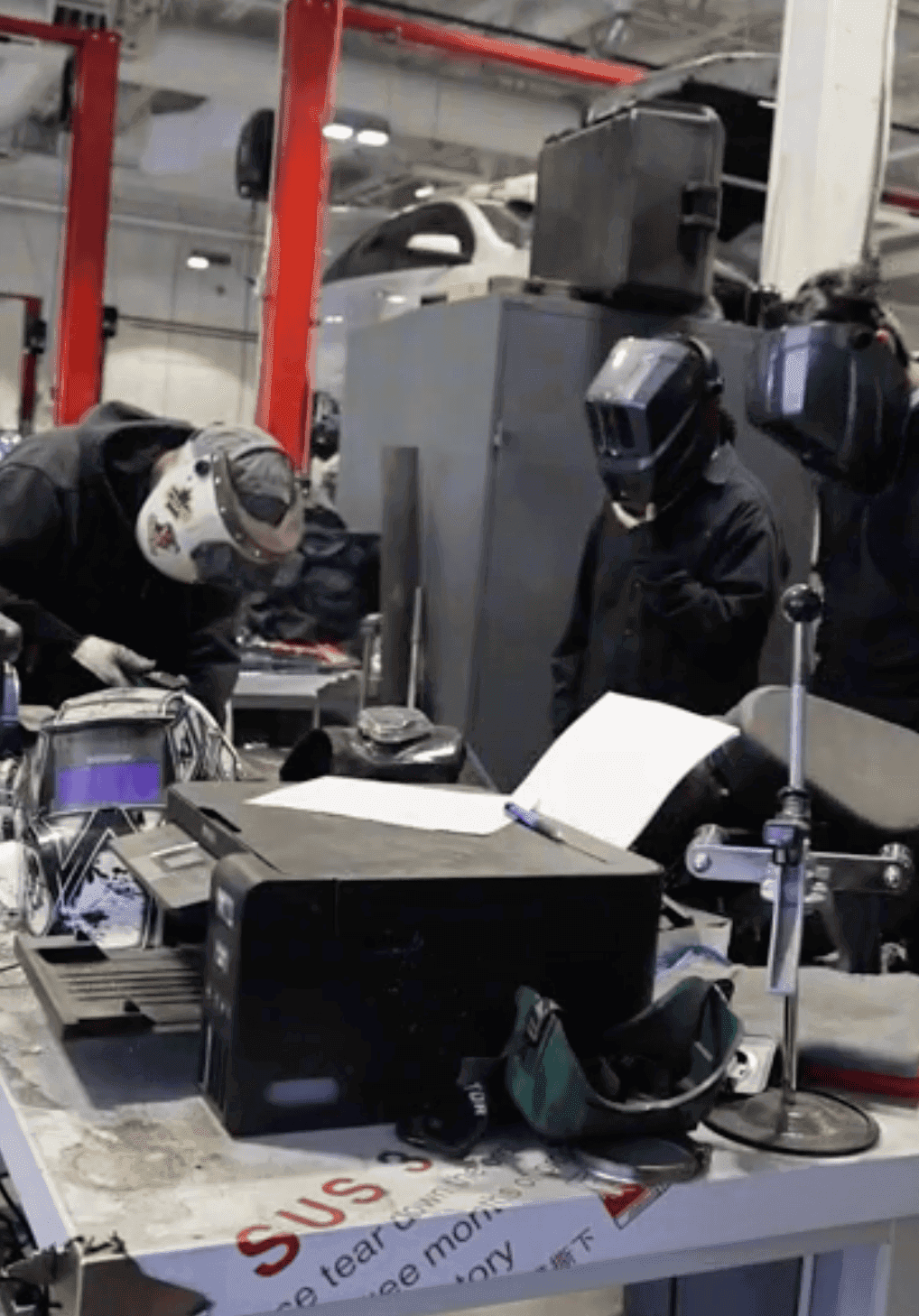 Students welding components in the fabrication shop